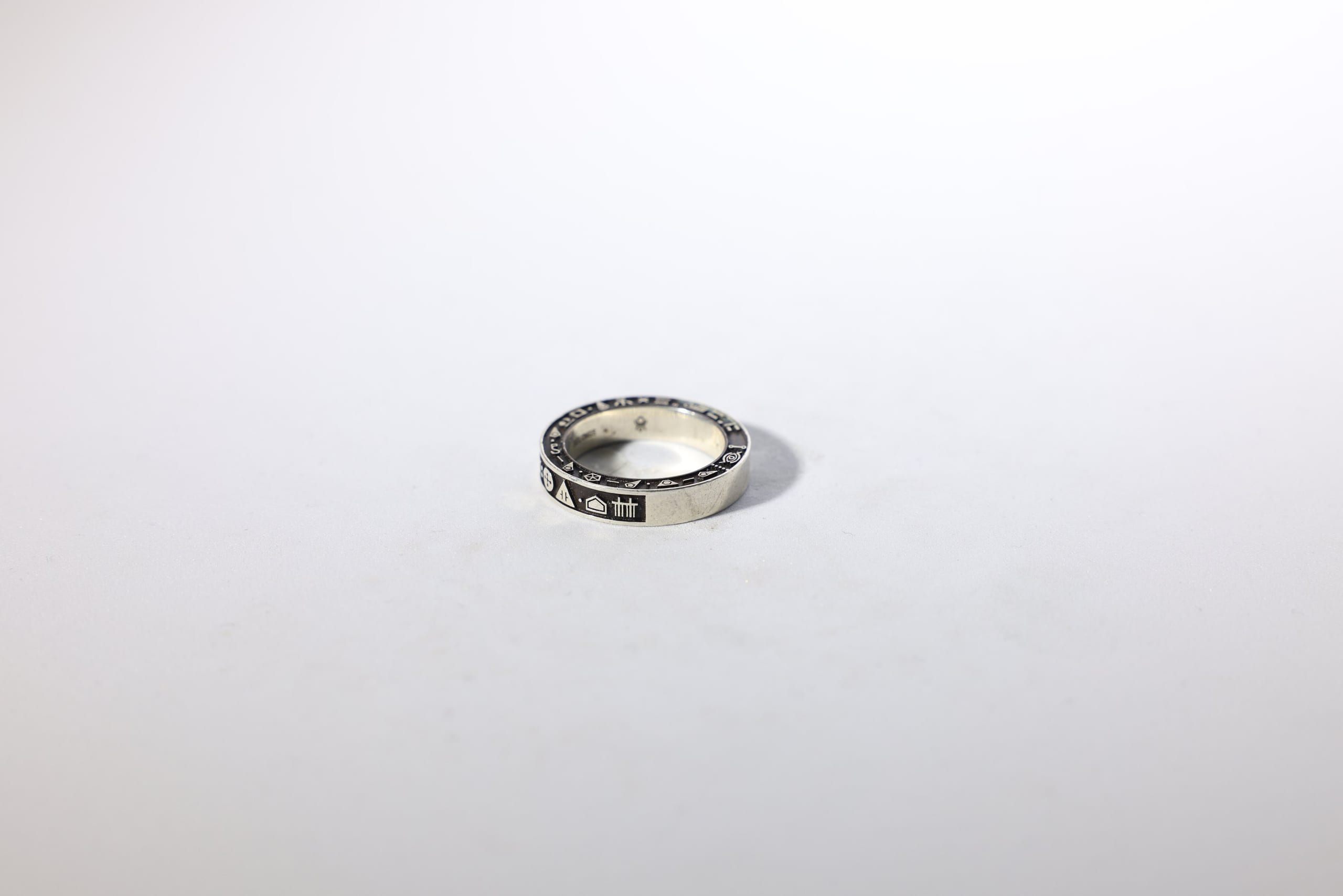 Signet ring engraved with bronze-script — on white