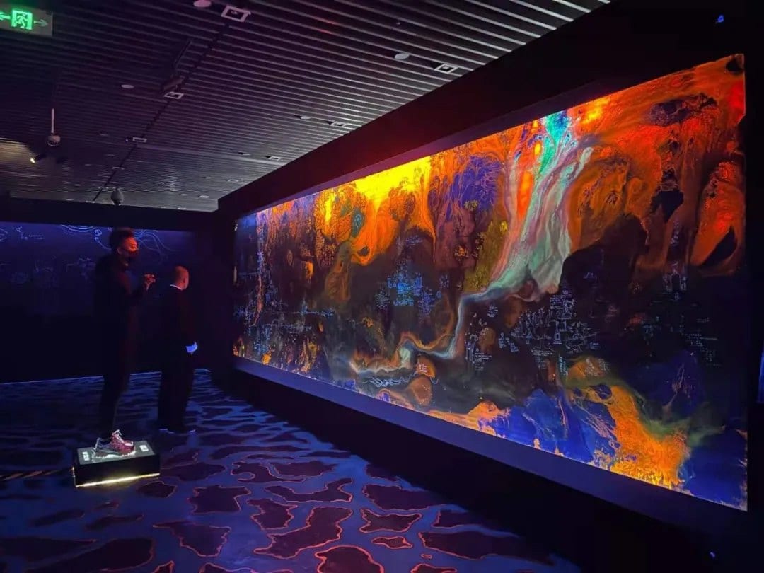 The Shanhai Map installed in a darkened gallery with visitors