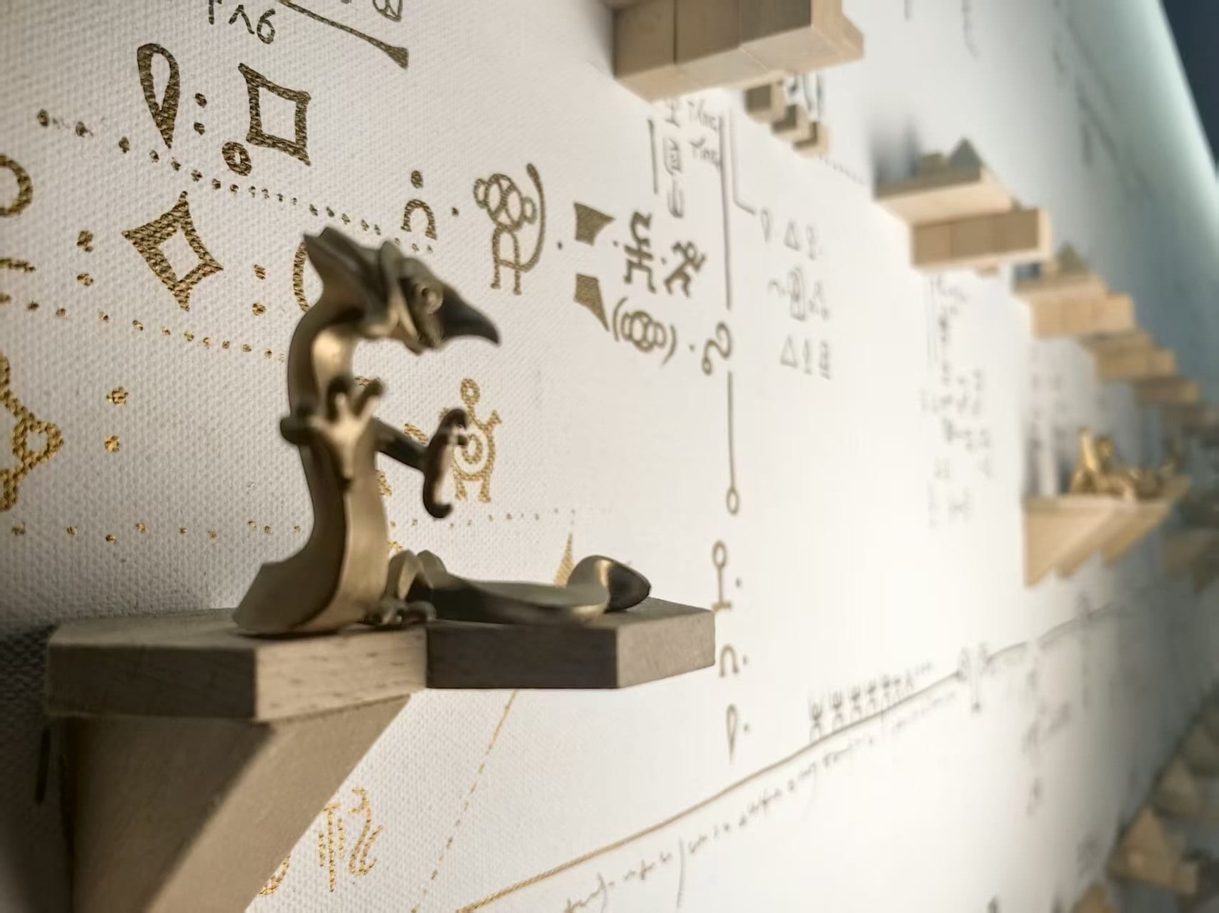 Shanhai Wall — gold figures on hexagonal shelves against a drawn map