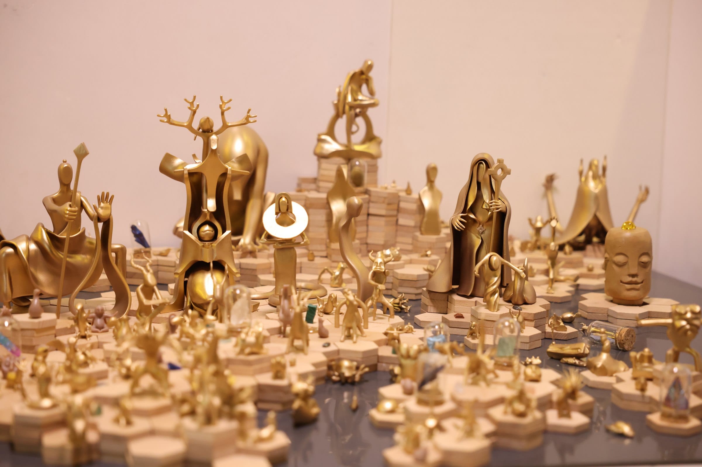 Shanhai World — gold-finished figures in the studio